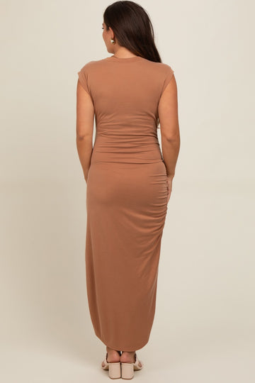 woman wearing a brown cap sleeve maternity maxi dress with back ruching detailing