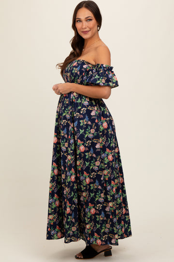 woman wearing a navy floral off-the-shoulder maxi dress with a visible baby bump