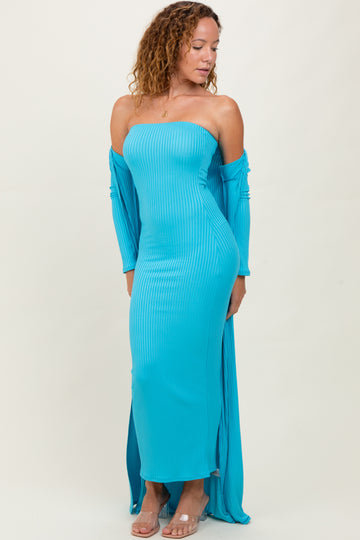 woman wearing a turquoise off-the-shoulder fitted maxi dress with long sleeves and side slits