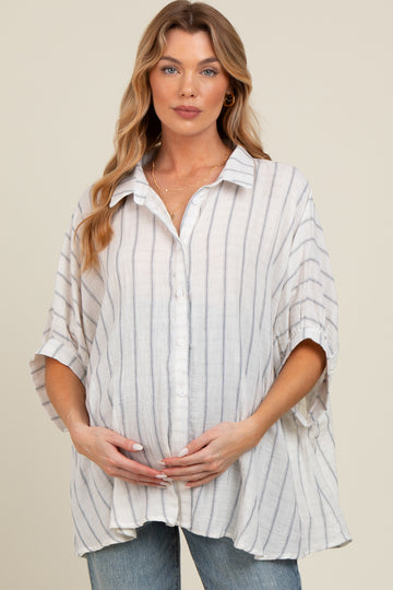 woman wearing a striped button-up maternity shirt with a loose fit and holding her baby bump