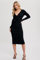 woman wearing a black ribbed wrap dress with long sleeves and a side tie detail