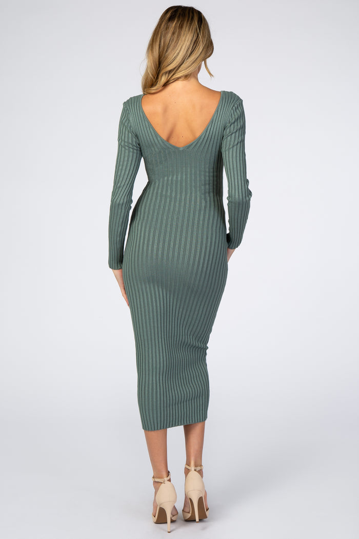 woman wearing a green ribbed maternity dress with a deep V back and long sleeves