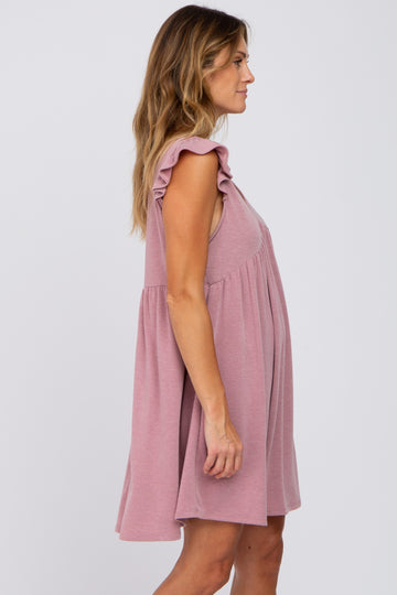 woman wearing a mauve ruffle sleeve maternity mini dress shown from a side profile view