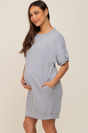 pregnant woman wearing a grey short sleeve maternity t-shirt dress with pockets